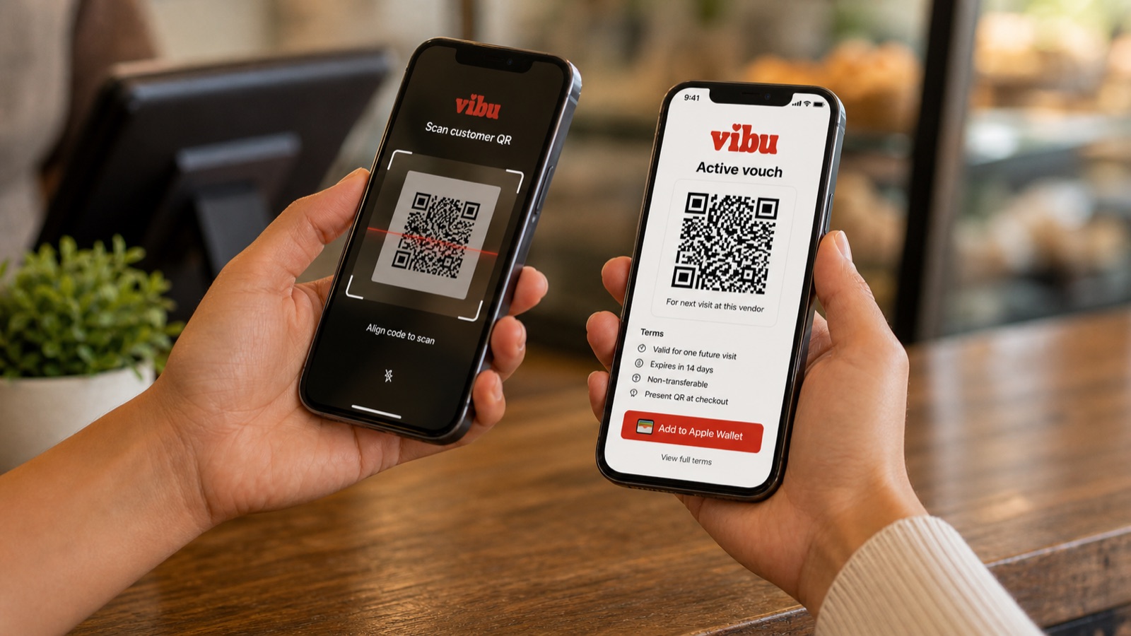 Two phones side by side over the counter. The vendor's phone on the left shows the Vibu scanner viewfinder ('Scan customer QR'). The customer's phone on the right shows the active voucher with QR code, terms, and Add to Apple Wallet and Google Wallet buttons.